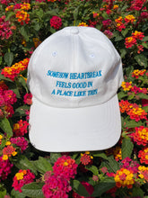 Load image into Gallery viewer, Somehow Heartbreak Feels Good In A Place Like This Hat
