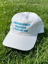 Load image into Gallery viewer, Somehow Heartbreak Feels Good In A Place Like This Hat